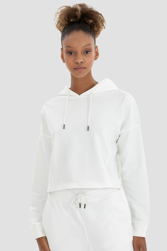 Woman with a cream crop hoodie
