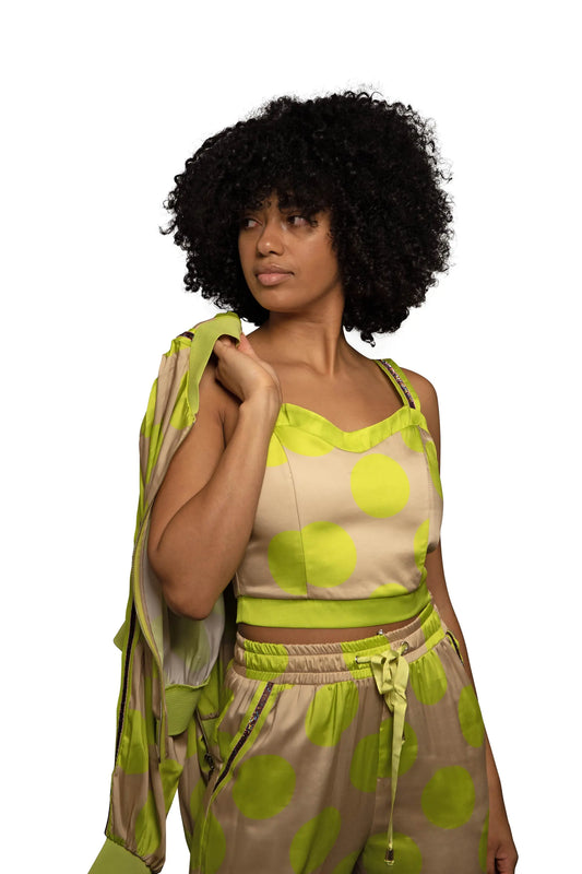 Model with a beige and neon green top, closeup