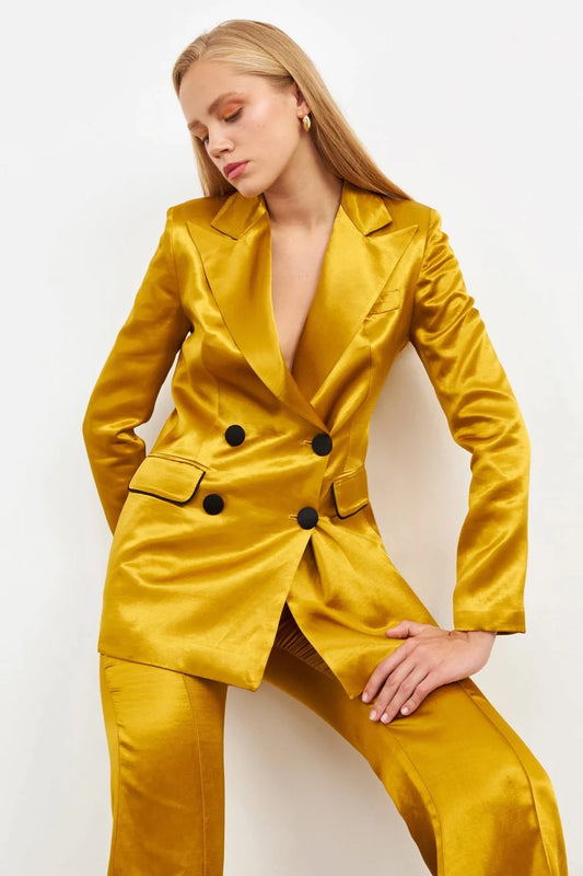 Model wearing a mustard colored silk suit